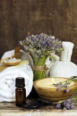 14884949-fresh-lavender-flowers-zen-stones-essential-oil-candle-herbal-massage-balls-and-towel-over-wooden-su